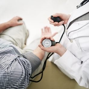 doctor measuring patient's blood pressure shot from above