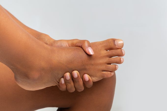 closeup of woman holding on to her foot