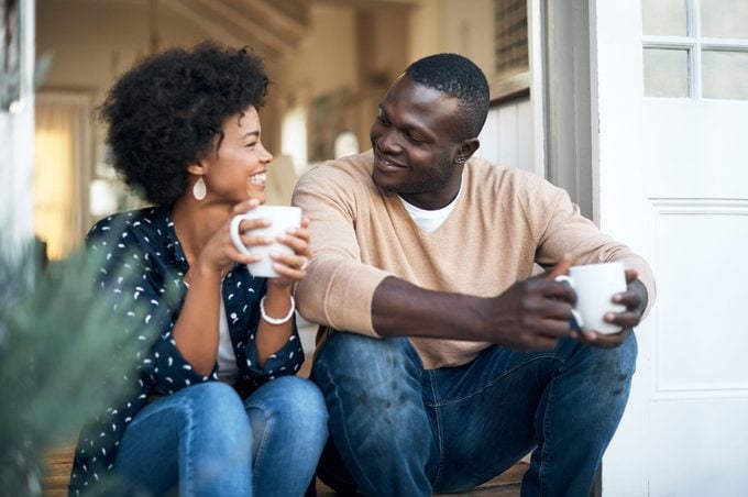 man and woman talking and drinking coffee and smiling