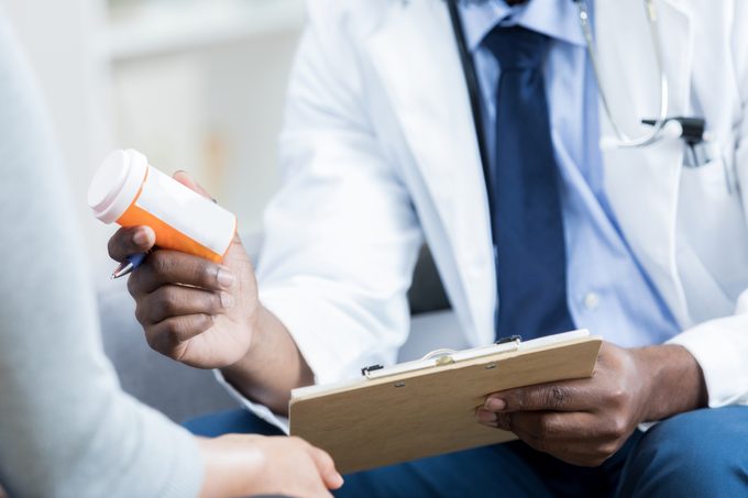 doctor gives patient prescription medication