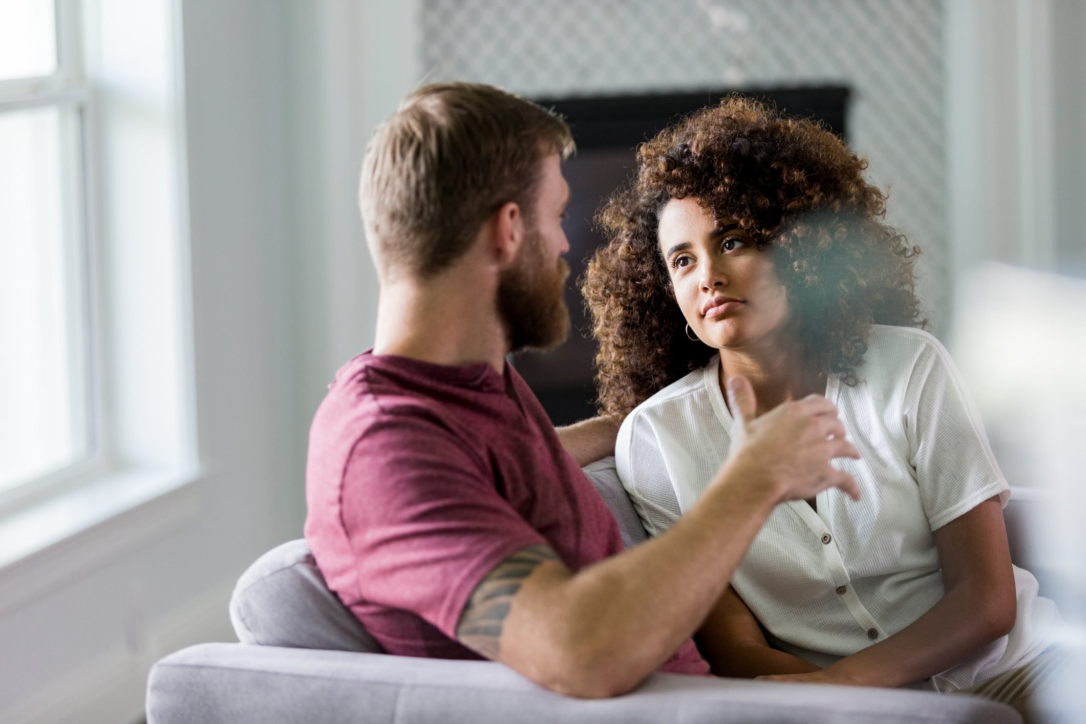 Mid adult woman listens seriously to husband's ideas