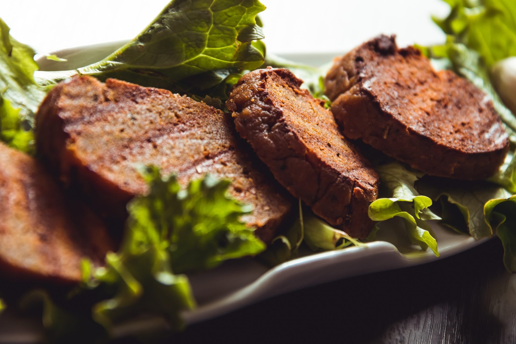 cooked seitan on bed of lettuce