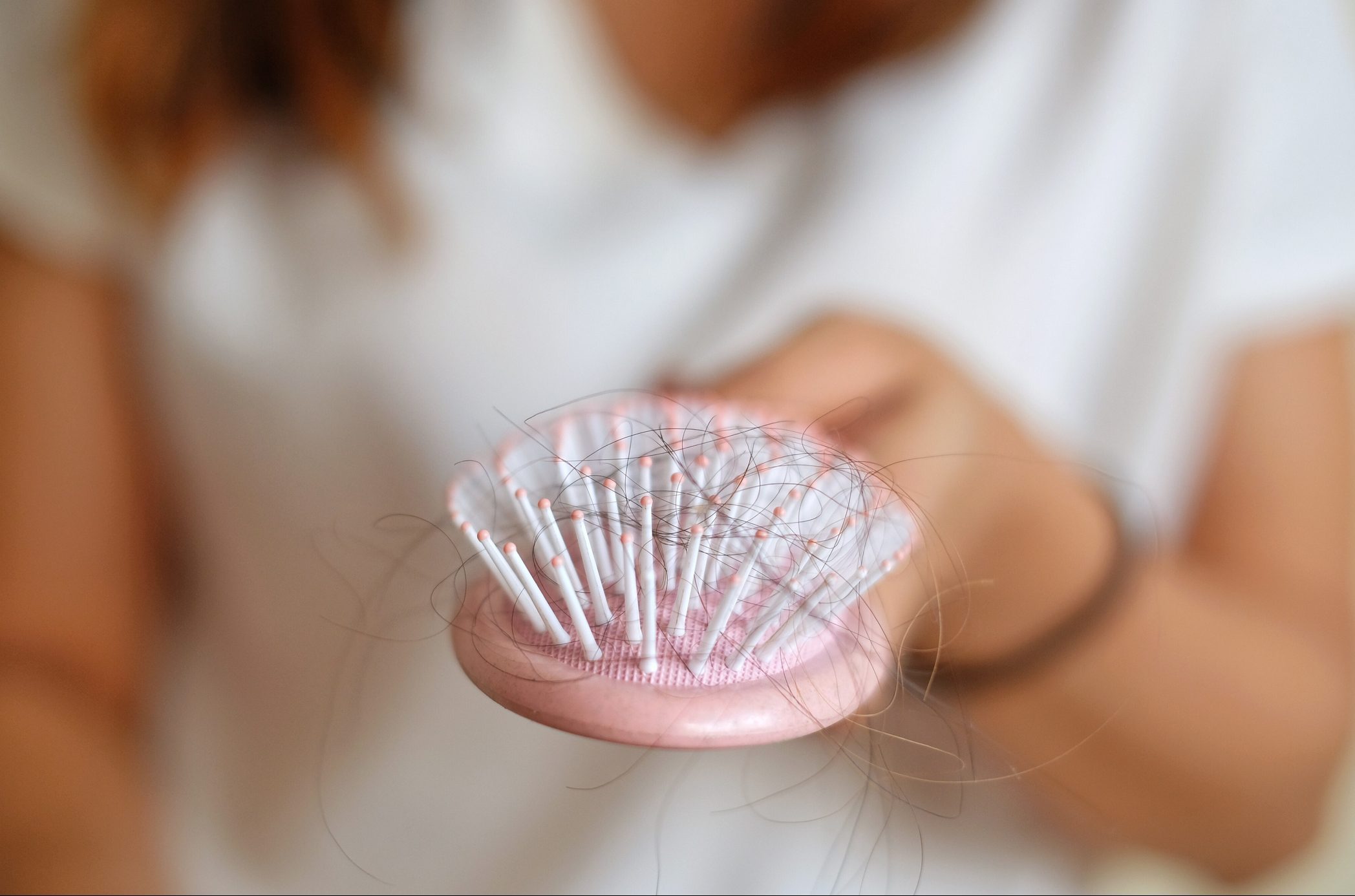 Midsection Of Woman Hairbrush With Fallen Hair