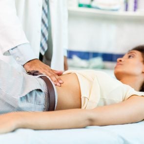 Woman with stomachache on medical exam