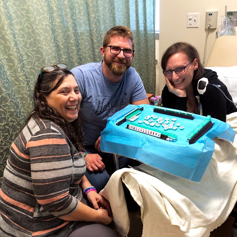 Janessa Schwartz in hospital beds with friends