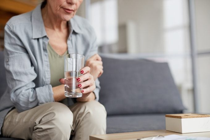 Worried Mature Woman Drinking Water