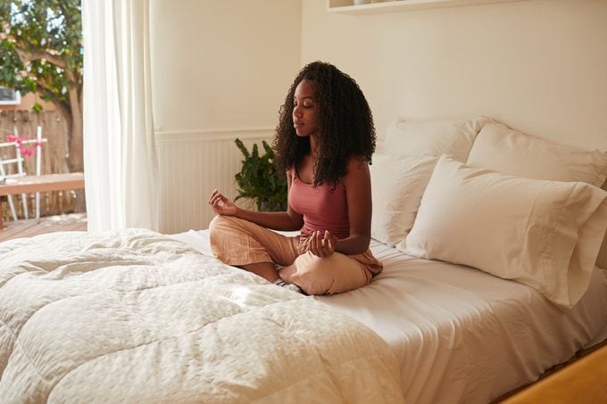 Young woman beginning her day with some meditation