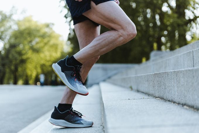 Close Up Of Legs Of man running up steps in sneakers