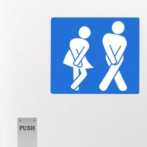Gender neutral toilet sign, legs crossed urgent need to urinate