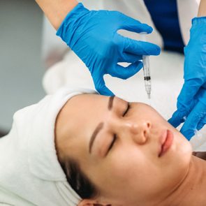 female receiving injection on the face at facial beauty salon