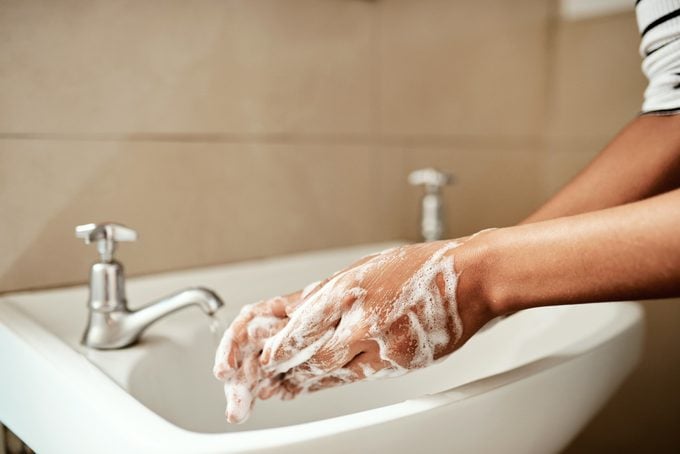 washing hands in bathroom sink close up