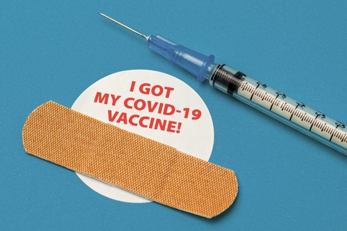 covid vaccine sticker and band aid and vaccine