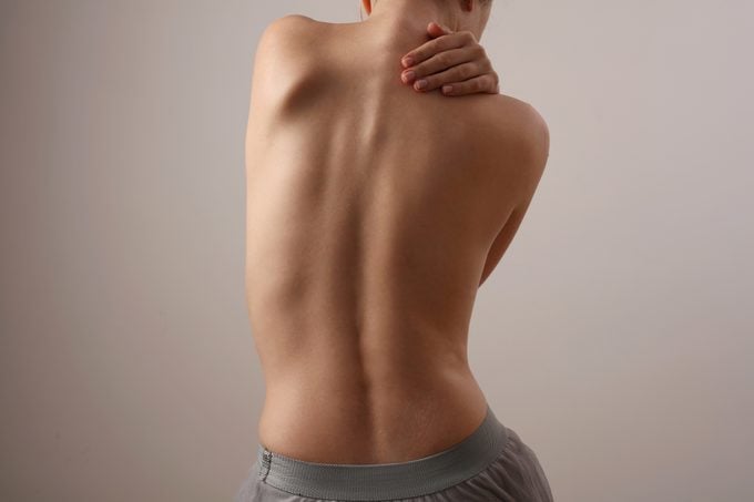 Woman with back pain, Scoliosis spine curve. Female body parts aesthetic, asymmetry