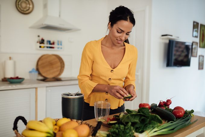 Attractive young vegan woman preparing food