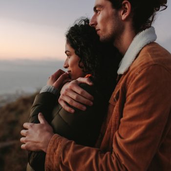 Romantic young couple standing in mountain