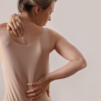 Woman with back and neck pain. Pure posture concept