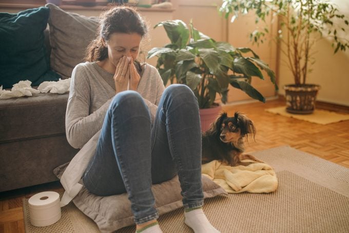 Woman suffering from allergies and flu at her home
