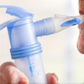 Close Up Of Elderly Man Using Nebulizer