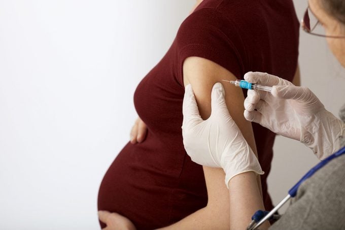 pregnant woman getting a vaccine shot