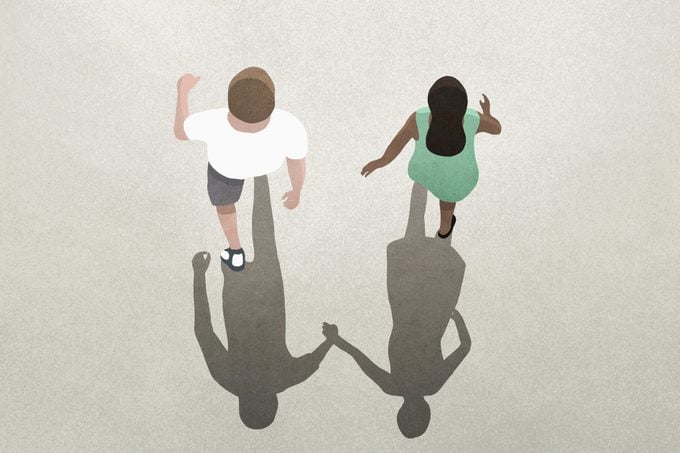 View from above shadow of couple holding hands