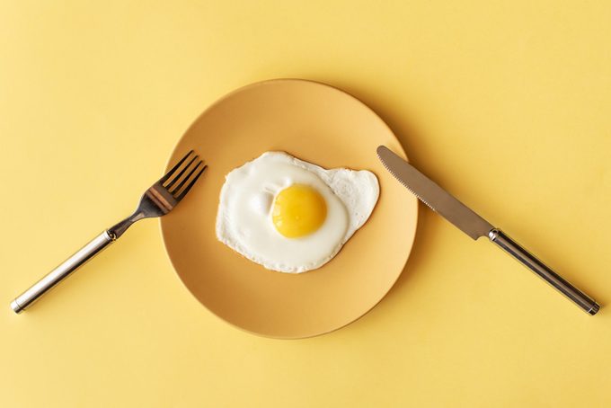 fried egg on yellow background, top view