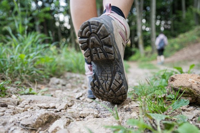 close up of woman's hiking shoes while walking on a hike
