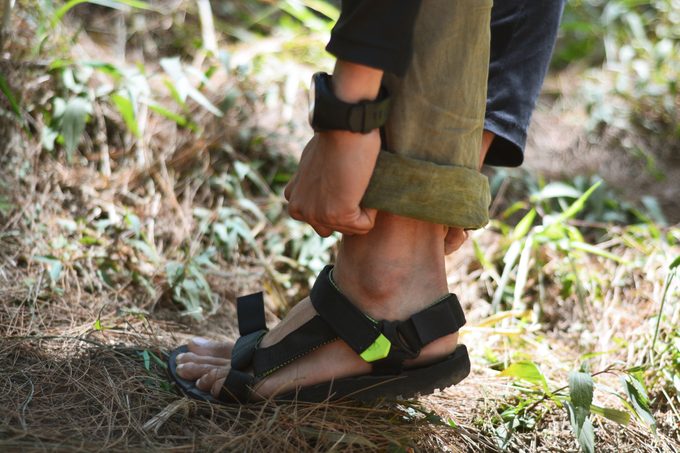 close up of woman wearing hiking sandals in nature