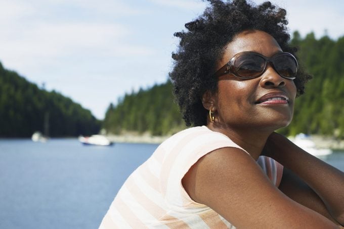 smiling woman wearing sunglasses in the summertime