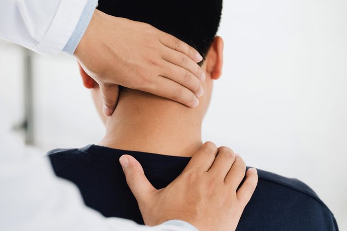 physiotherapist examining patient's neck for trigger points
