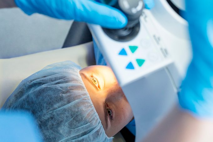 person on operating table for lasik eye surgery
