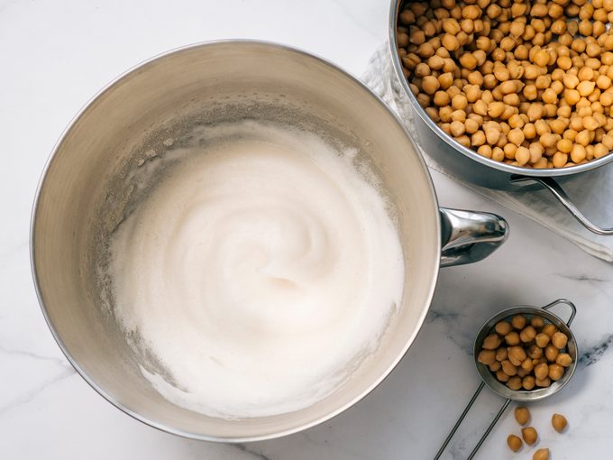Whipped chickpea aquafaba in mixer bowl