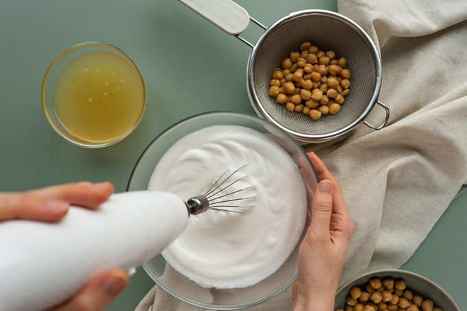 hands mixing aquafaba, vegan egg substitute