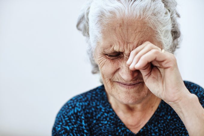 Senior woman rubbing her eye