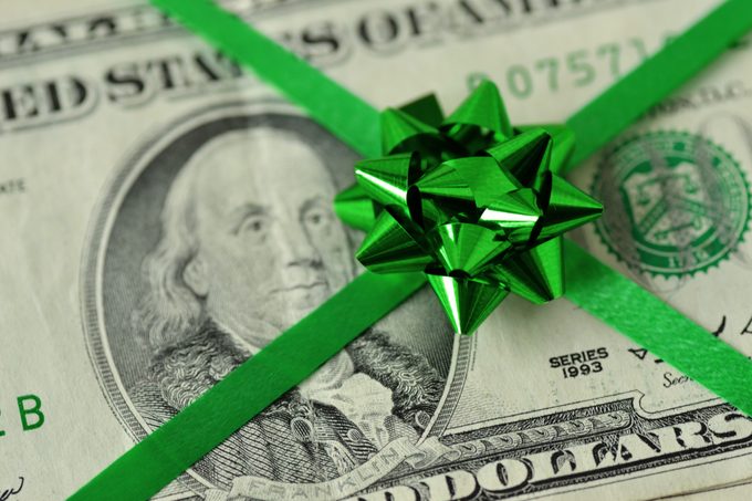Close-Up Of money With green christmas Ribbon
