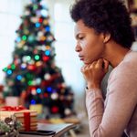 worried woman sitting near the christmas tree