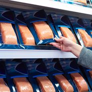 Salmon fish in hand of buyer at store