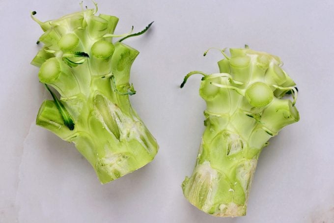 Close-Up Of Broccoli Stalks On White Table