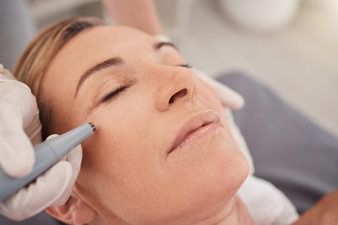 Closeup shot of a mature woman enjoying a micro-needling treatment at a spa