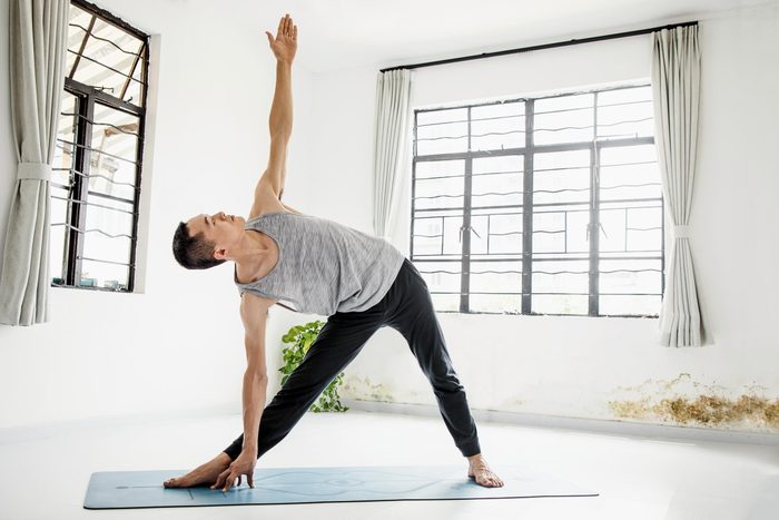 man inside does bone strengthening yoga pose, the triangle