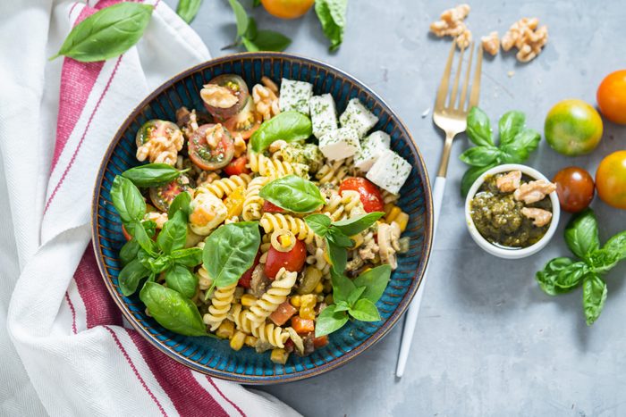 Summer chickpea pasta salad with tomatoes and basil