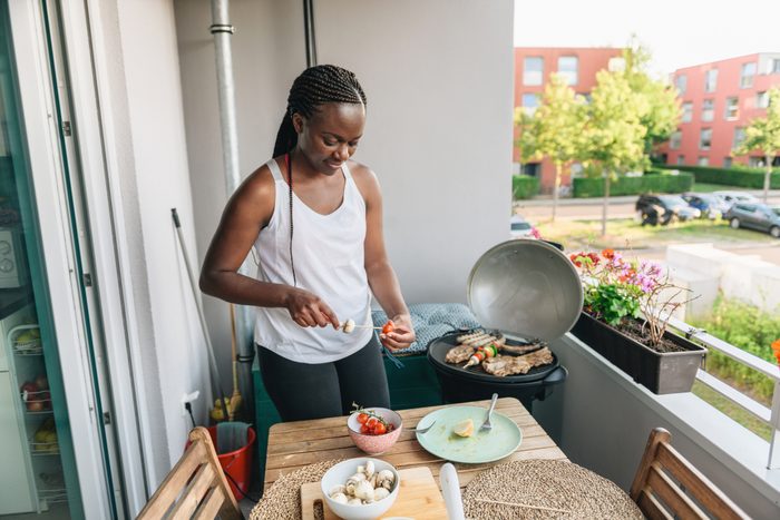 woman preparing vegetarian skewers fot barbecue grill