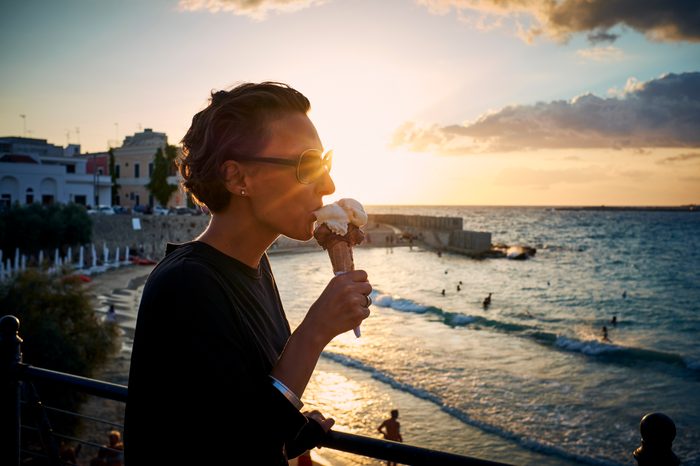 woman eating ice cream cone in italy