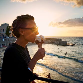 woman eating ice cream cone in italy