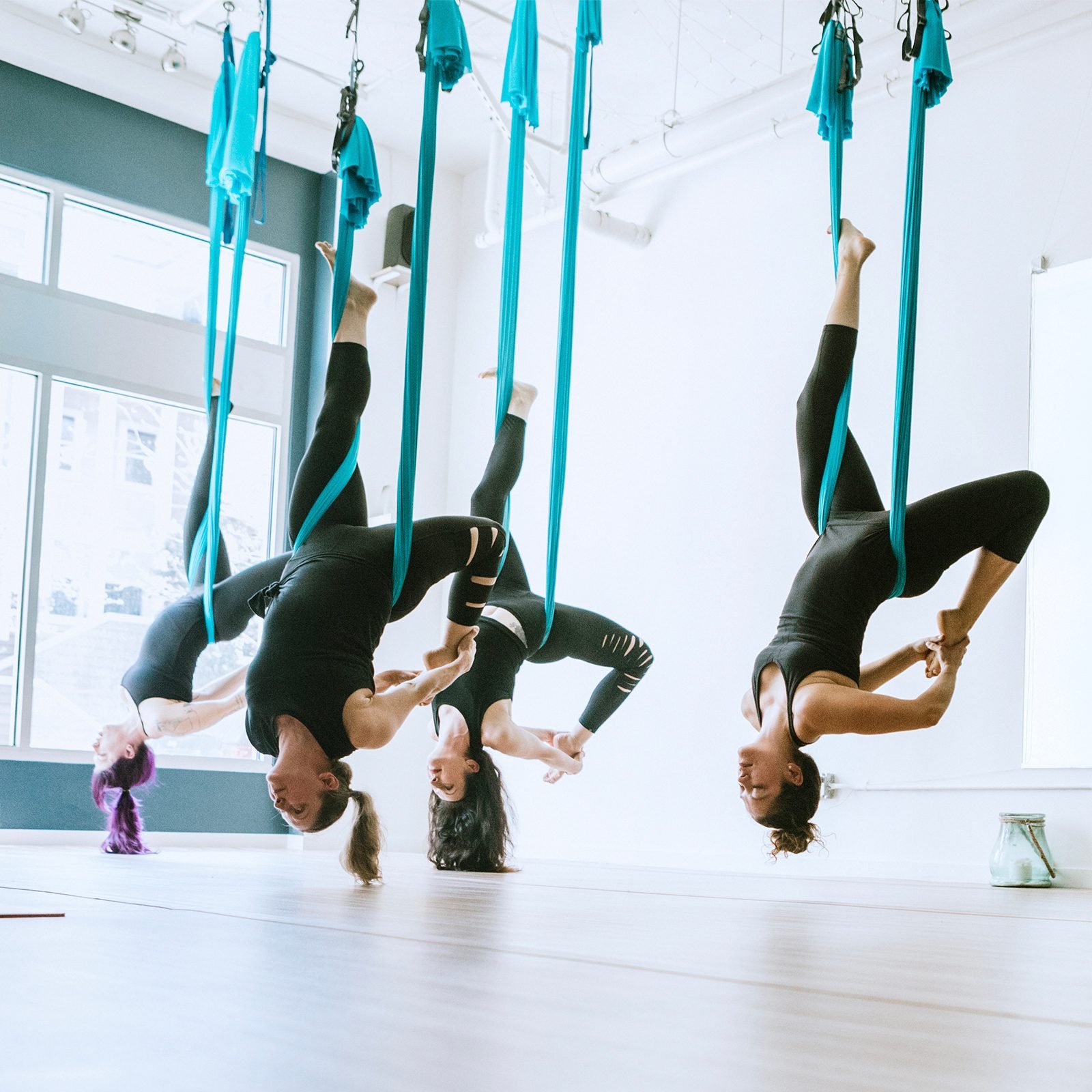 Women exercising aerial yoga