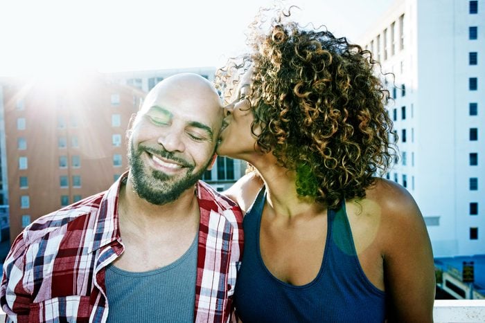 Couple kissing On a Sunny urban Rooftop