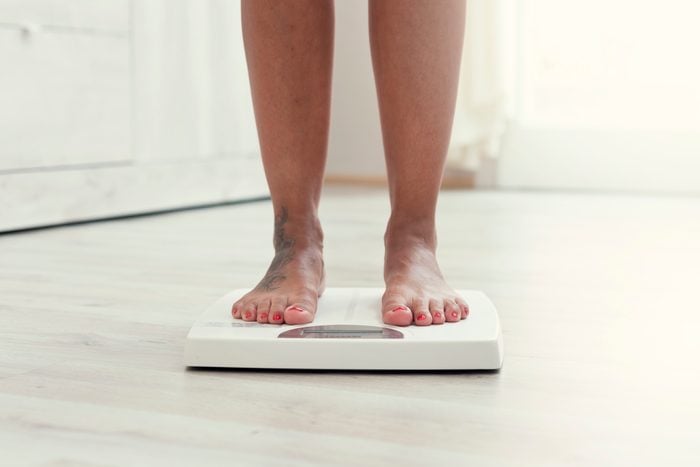 Woman standing on the weight scale