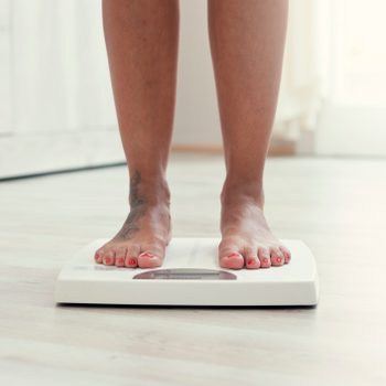 Woman standing on the weight scale