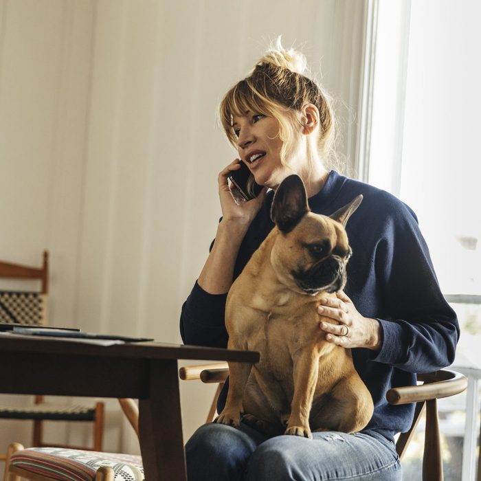 Woman working at home with dog