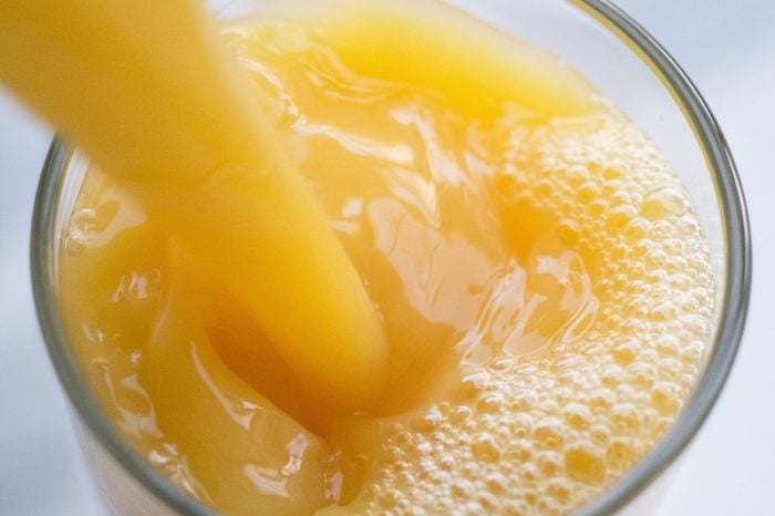 close up of Orange Juice Pouring into a glass
