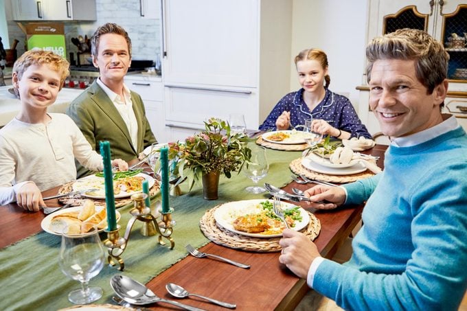 Neil Patrick Harris and David Burtka at the dinner table with their son and daughter